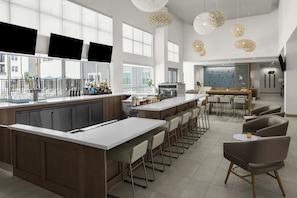 Une cuisine moderne dotée d’un îlot central, d’un bar et d’un espace repas.