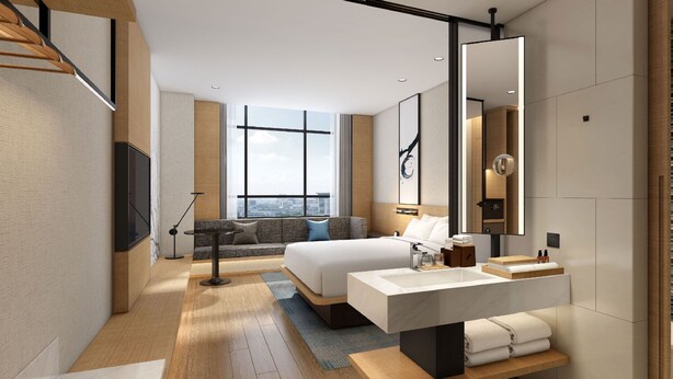 A modern hotel room with a large bed, a desk with a mirror, a TV, and a city view through large windows. - Fairfield by Marriott Hangzhou Qiantang (Hangzhou)