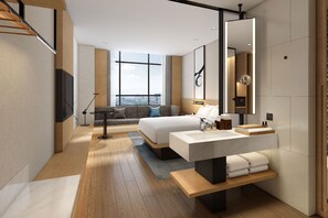 A modern hotel room with a large bed, a desk with a mirror, a TV, and a city view through large windows. - Fairfield by Marriott Hangzhou Qiantang (Hangzhou)