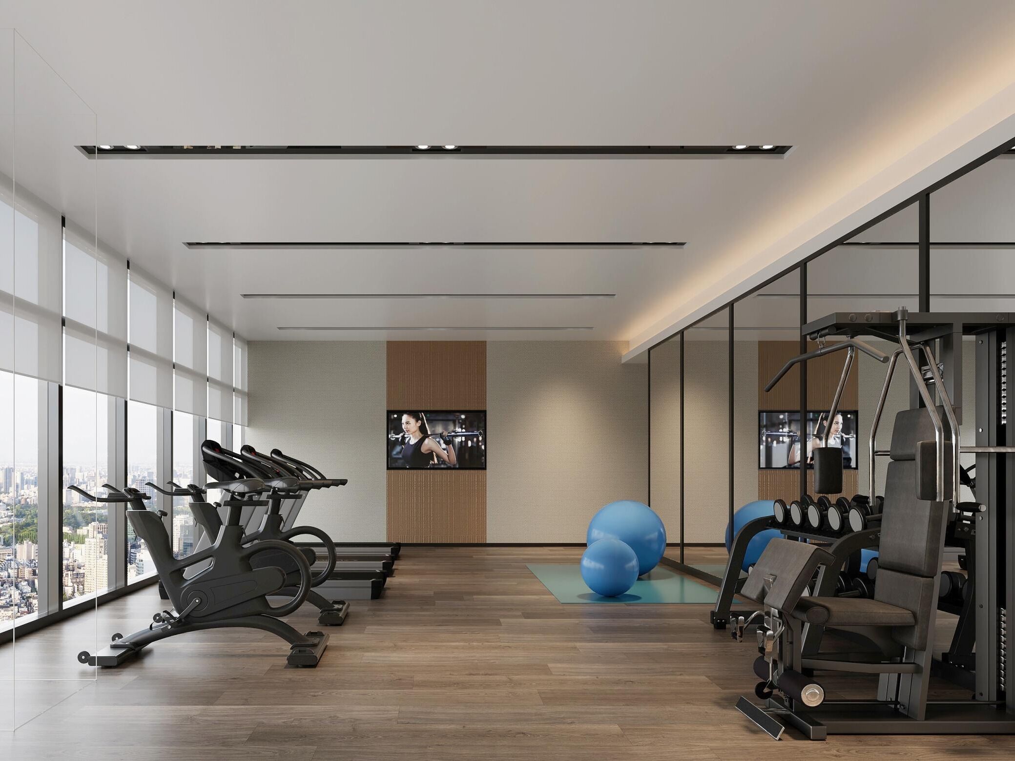 A modern gym with exercise equipment, large windows, and a city view.