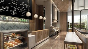 A modern cafe with a chalkboard menu, a wooden reception desk, and a glass display case with pastries. - Fairfield by Marriott Hangzhou Qiantang (Hangzhou)