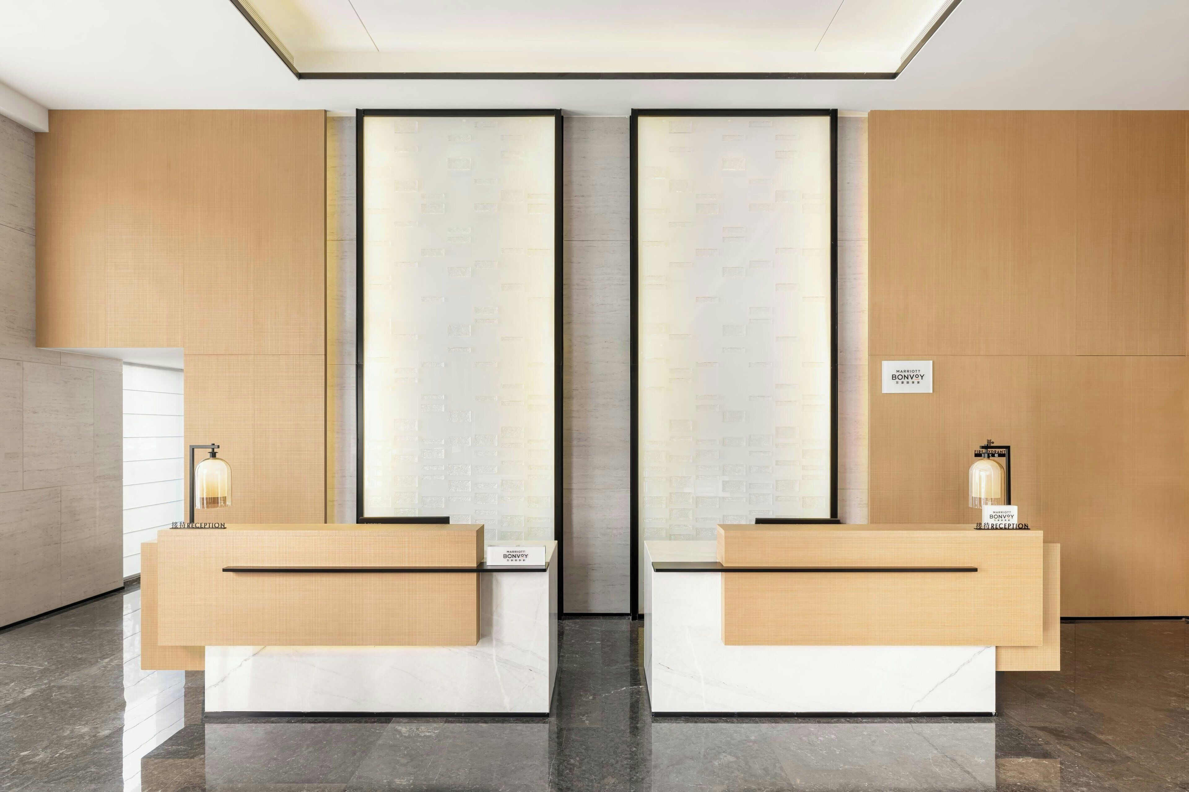 A reception area with two counters, a modern design, and a sign indicating the location.