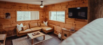 The Hideout - Escape to The Hideout in Hocking Hills, OH! This cozy, pet-friendly cabin offers a private deck by Pine Creek, just minutes from hiking, waterfalls, and caves. Perfect for up to 4 guests. Book your nature-filled getaway today!
