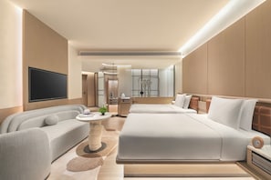 A modern hotel room with a large bed, a sofa, a TV, and a small table with a plant. - Hotel Indigo Hainan Clear Water Bay by IHG (Lingshui)