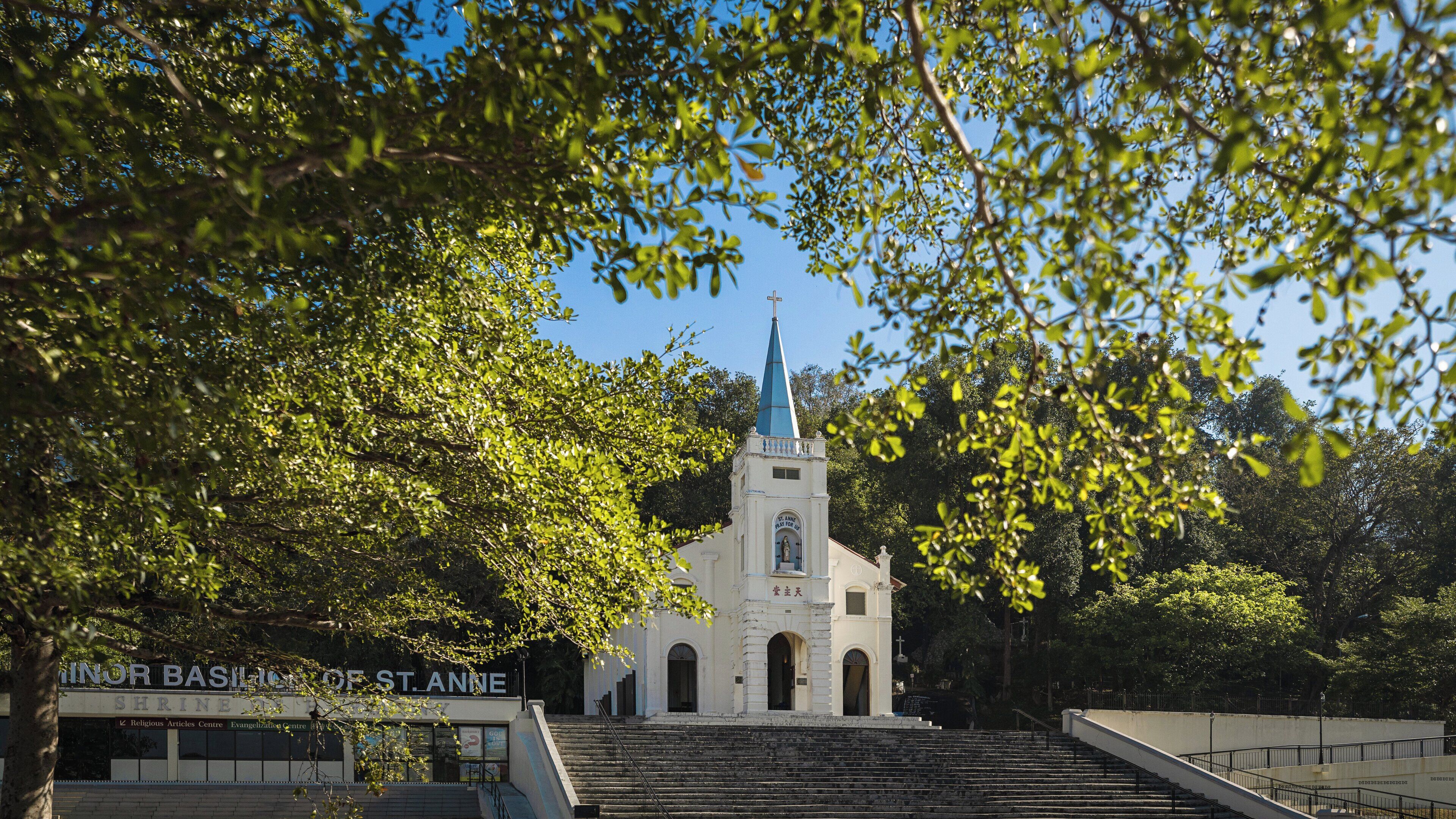 A church with a steeple and a sign reading "Minor Basilica of St. Anne".