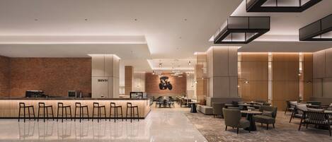 A modern hotel lobby with a bar area, seating arrangements, and a brick wall.