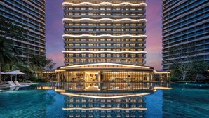 A modern hotel with a unique curved facade, a central courtyard, and a reflective pool. - Crowne Plaza Sanya Yazhou Bay by IHG (Sanya)
