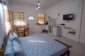 Cozy retreat with a single bed, desk, and TV, perfect for a relaxing stay.
