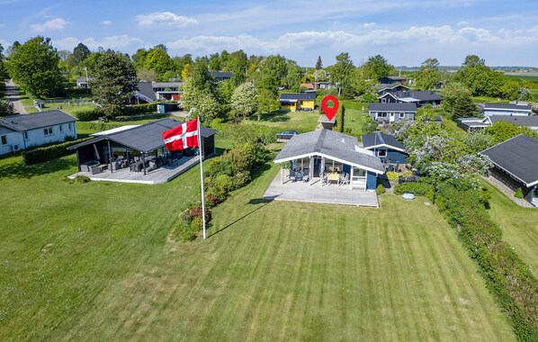 An aerial view of a residential area with houses, a flagpole with a flag, and well-maintained lawns. - Beautiful home in Odder with WiFi (Odder)