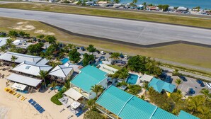 A coastal hotel with multiple buildings, a swimming pool, and a beach area. - Cocos Beachfront Breeze (Simpson Bay)