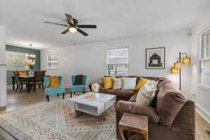 Cozy living space with a leather sofa, coffee table, and armchair, perfect for relaxing and dining.