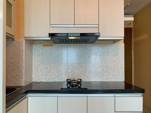 Apartament Deluxe | Cuina privada | Frigorífic, placa de cuina i arrossera 