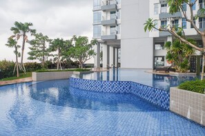 Relax by the pool surrounded by lush greenery and enjoy the hotel's contemporary design.