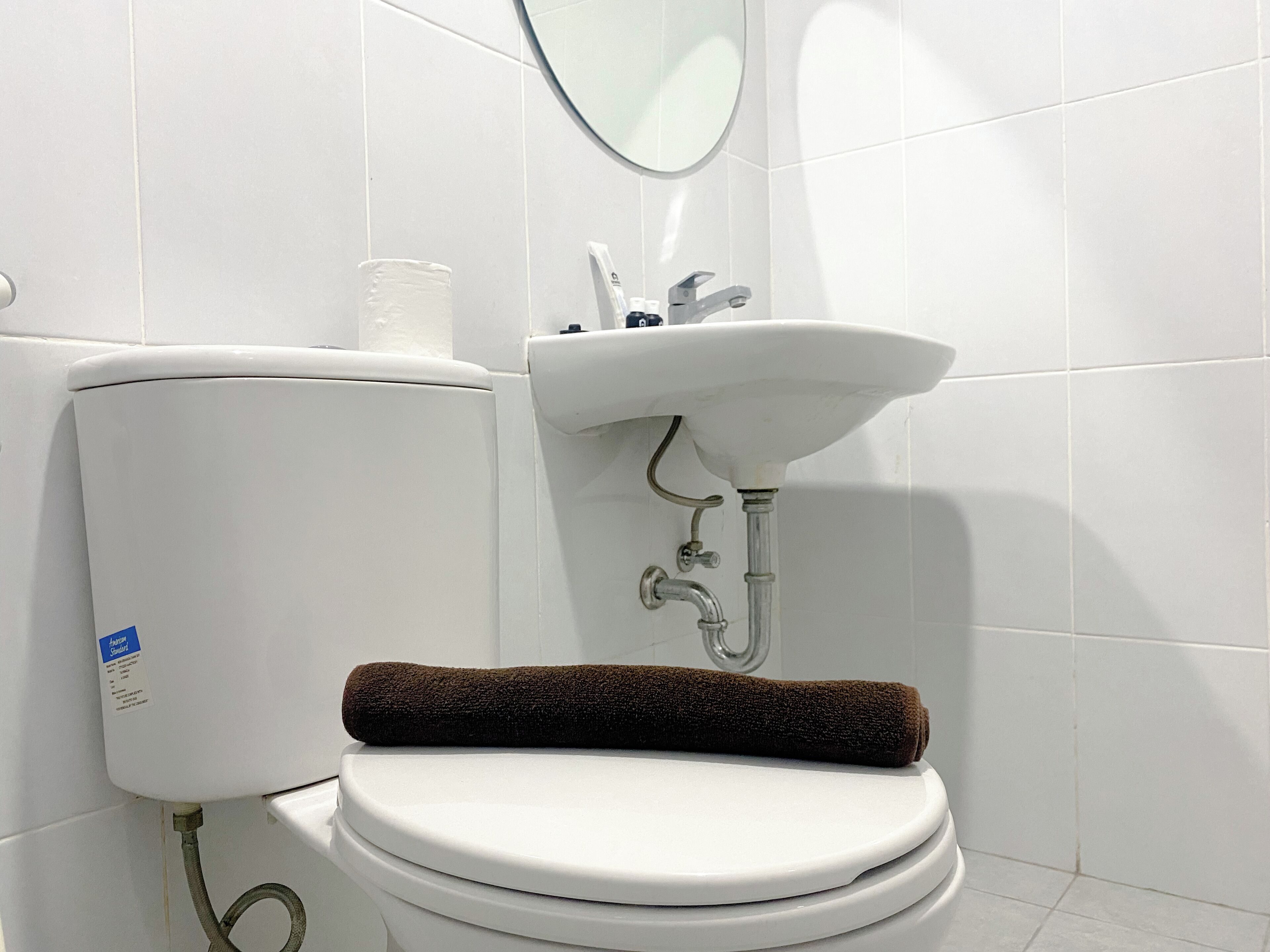 A bathroom with a toilet, a sink, and a towel.