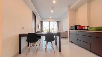 Deluxe Apartment | Private kitchen | Fridge, microwave, rice cooker, dining tables