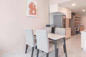 Enjoy family meals and intimate gatherings in this stylish dining area with a central table and comfortable seating for four.