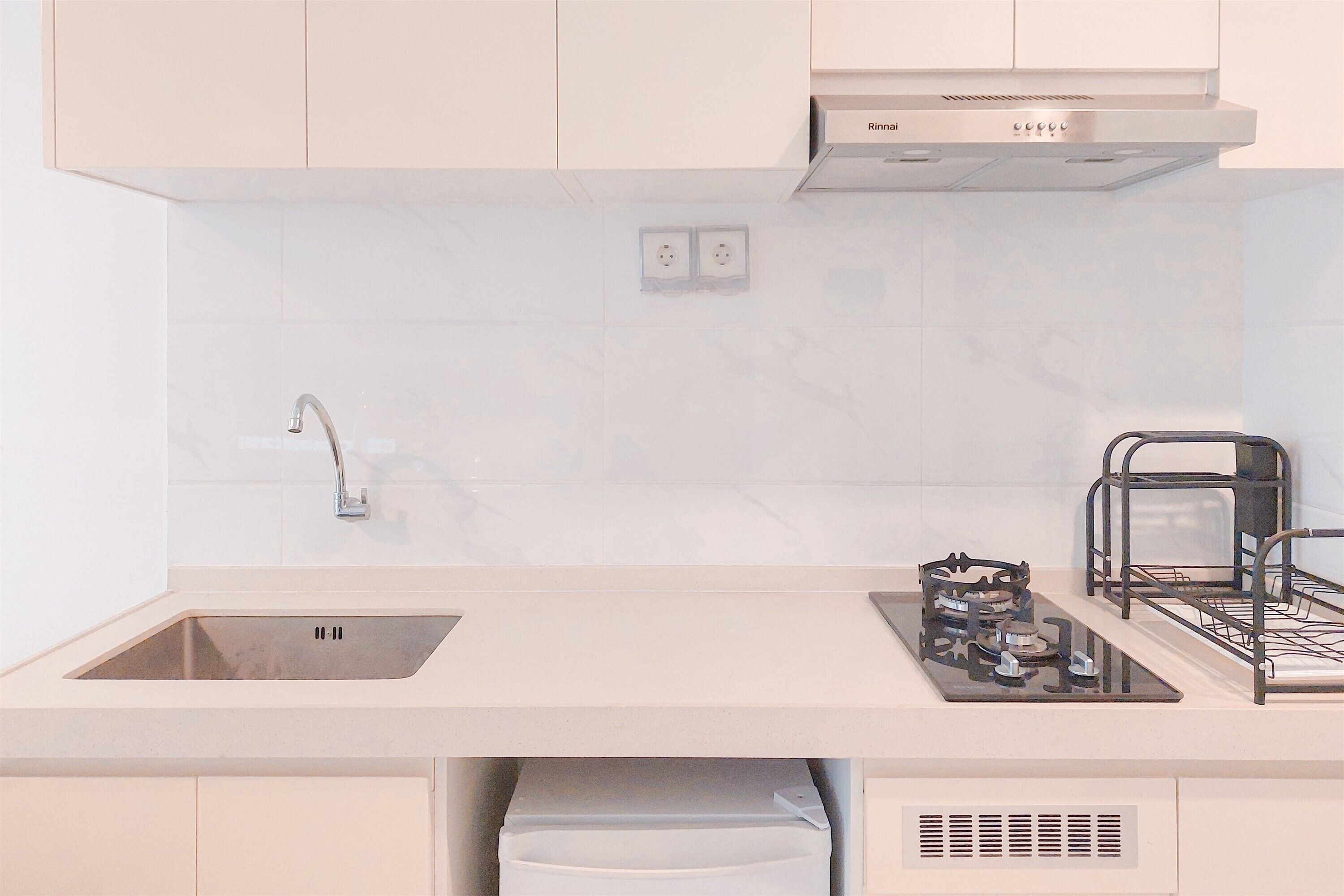 A modern kitchen with a stainless steel sink, a gas stove, and a built-in oven.