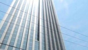 A tall, modern building with a glass facade and vertical lines. - Good And Homey Studio At The Pinnacle Apartment (Semarang)
