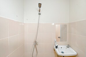 A bathroom with a shower, sink, and mirror. - Good And Homey 2Br At Apartment Green Palm Residence (Jakarta)