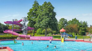 A swimming pool with multiple lanes, a water slide, and a playground area. - Nice home in Heinkenszand with WiFi (Heinkenszand)