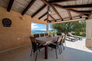 Enjoy meals in this dining area with a table for four, a dartboard, and a scenic view.