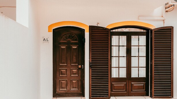 A set of three doors with a brown finish, each with a different style of window and door design. - Altura Beach Villa by GT House (Castro Marim)
