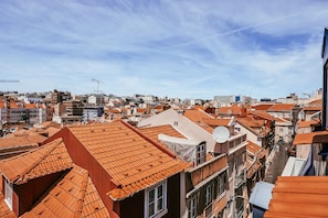 A cityscape with densely packed buildings, red-tiled roofs, and a clear sky. - Central & Typical Lisboa by GT House (Lisbon)