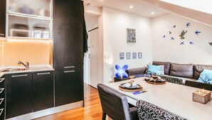 A modern kitchen with dark cabinets, a white countertop, and a built-in oven. - Central & Typical Lisboa by GT House (Lisbon)