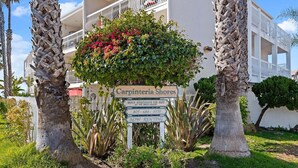 A sign for 'Carpinteria Shores' with a contact number and 'NOW RENTING' text. - Beachfront Ocean View Condo | California King, Balcony & Steps to the Sand (Carpinteria)