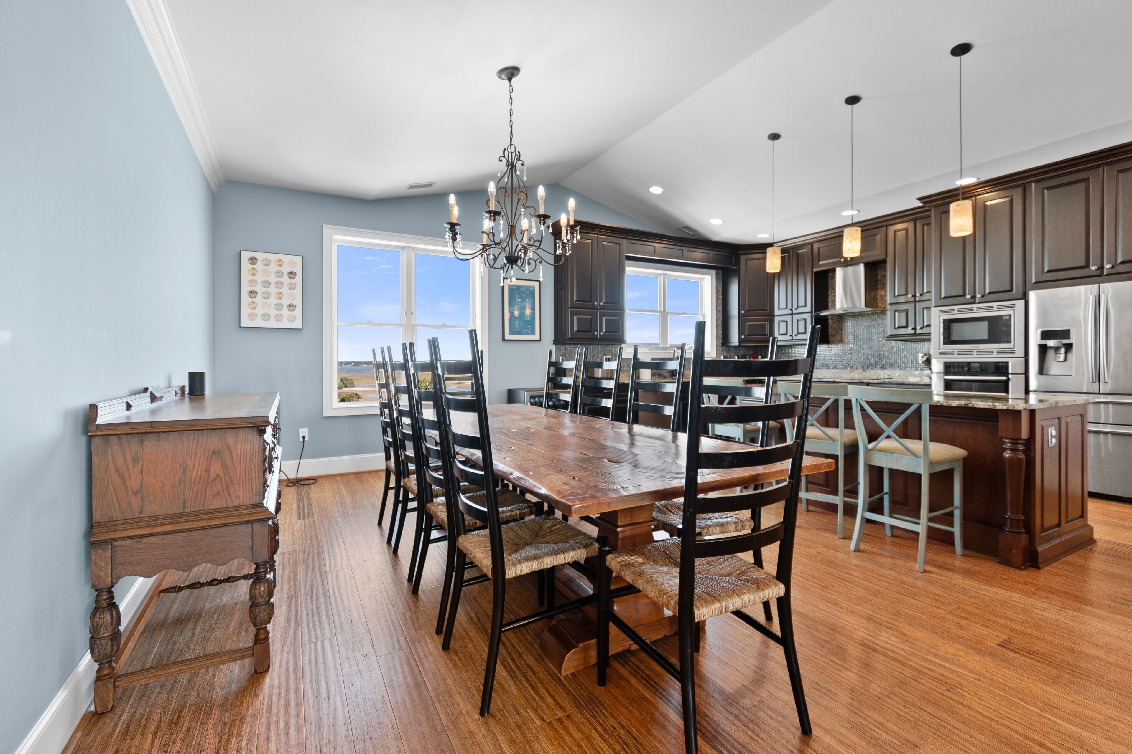 A spacious kitchen with dark wood cabinets, a large island, and modern appliances.