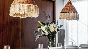 A kitchen with two woven pendant lights, a vase with flowers, and a granite countertop with plates and glasses. - Luxury Penthouse with Private Pool in Tulum by BT Homes (Tulum)