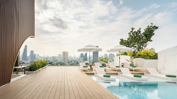 A rooftop pool area with lounge chairs, umbrellas, and a city skyline view. - Somerset Sukhumvit 71 Bangkok (Bangkok)