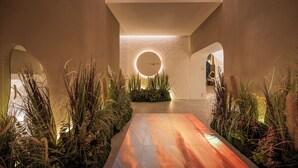 A modern interior with a central walkway, circular lighting, and indoor plants. - Somerset Sukhumvit 71 Bangkok (Bangkok)