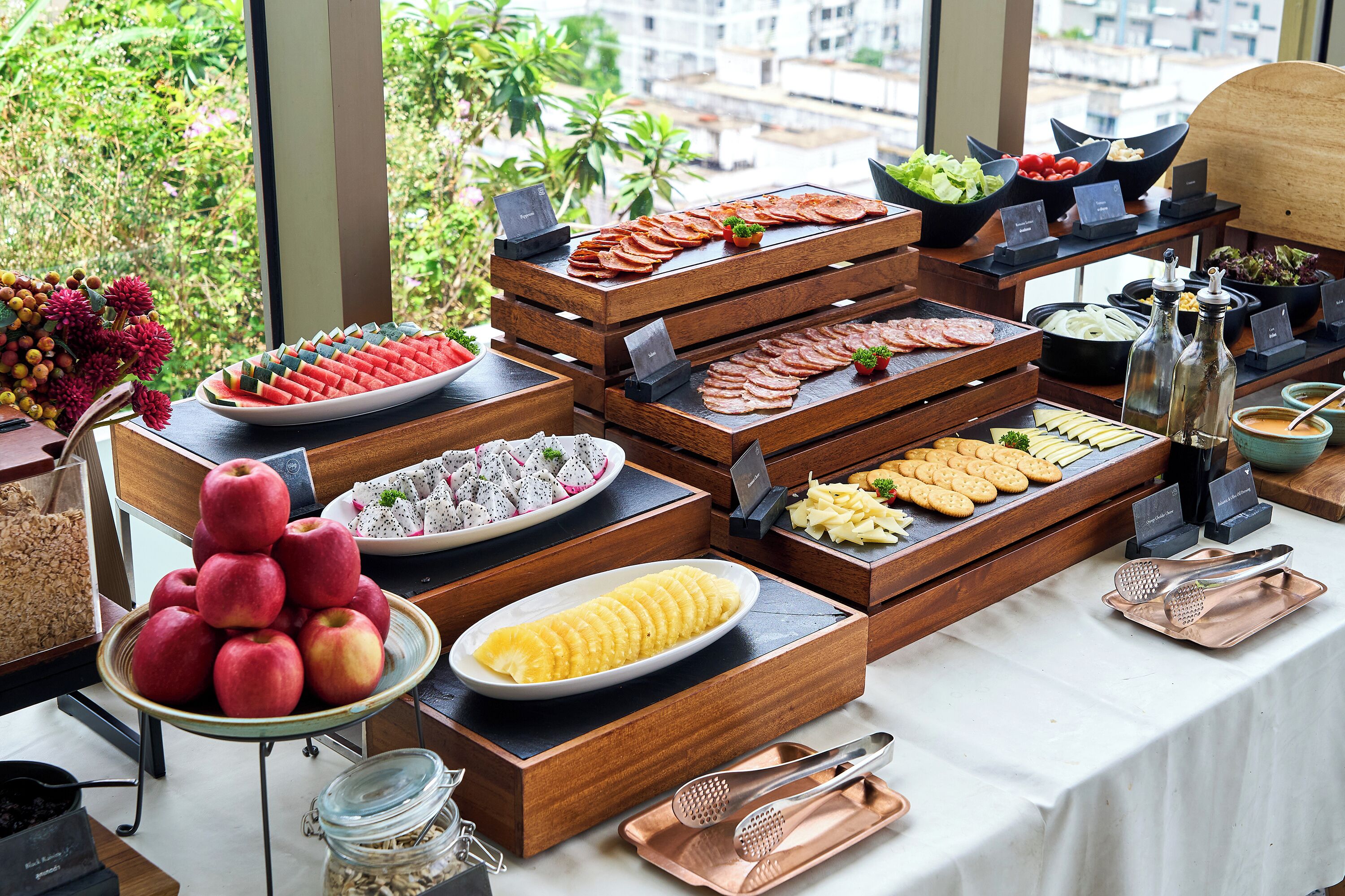 A buffet with various food items and utensils.