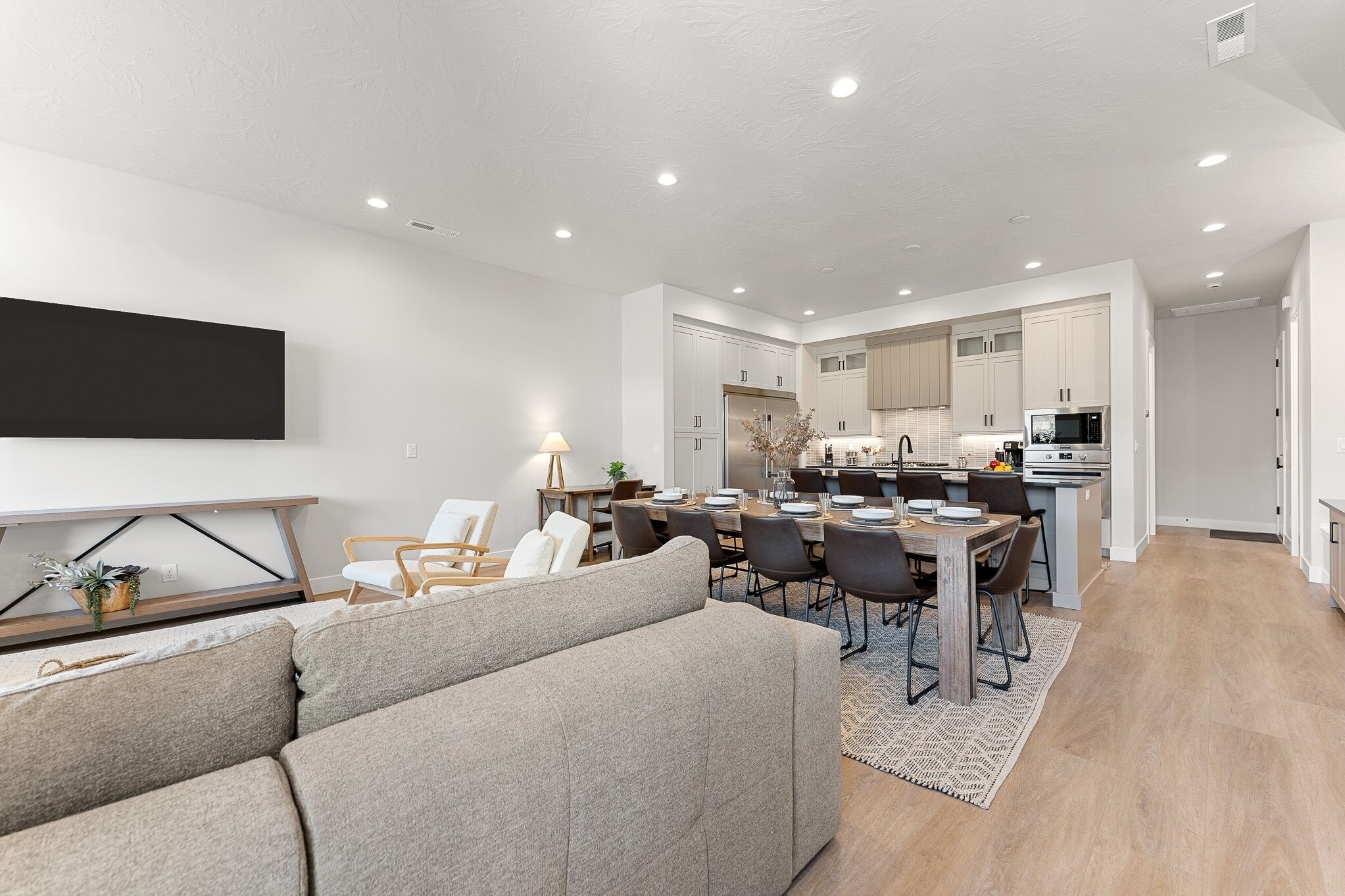 A modern apartment with a living room, dining area, and kitchen.