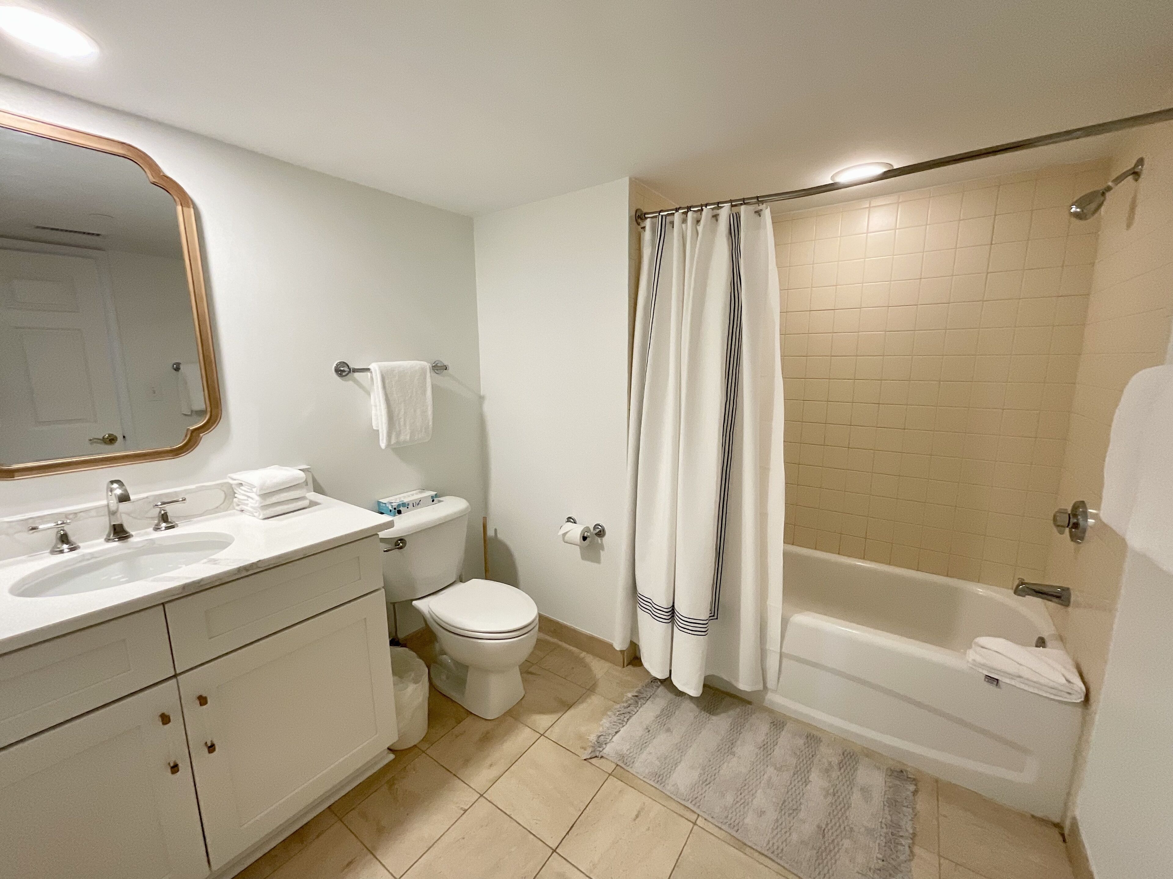 A bathroom with a sink, toilet, and bathtub.
