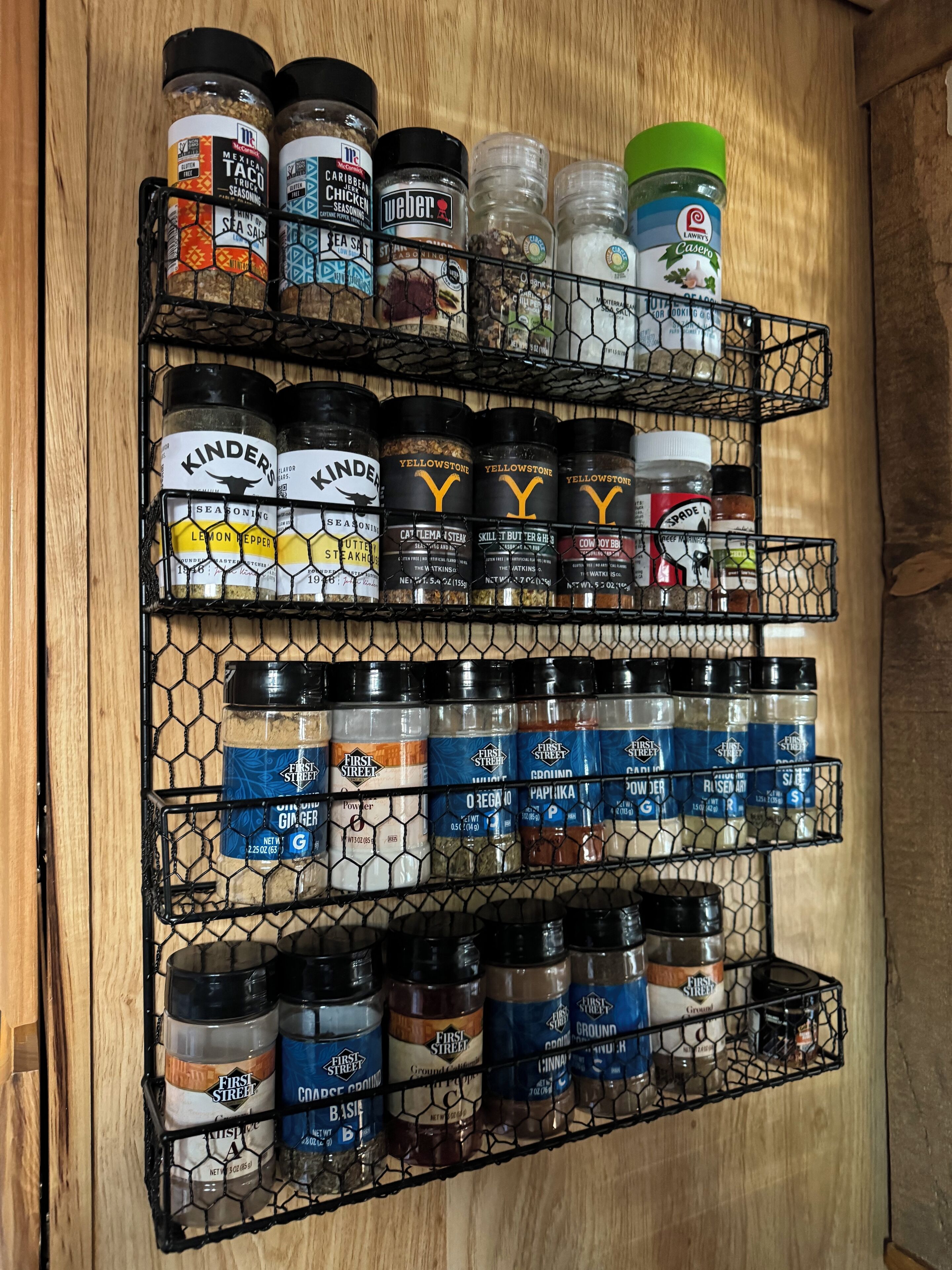 A spice rack with various seasoning bottles.