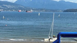 A coastal view with boats and a large ship in the distance. - Private Garden Suite Close to UBC, Airport & Downtown (Vancouver)
