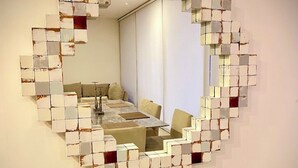 A circular mirror with a mosaic of tiles on the wall. - Exclusive Solaria Arch View Penthouse with Jacuzzi (Cabo San Lucas)