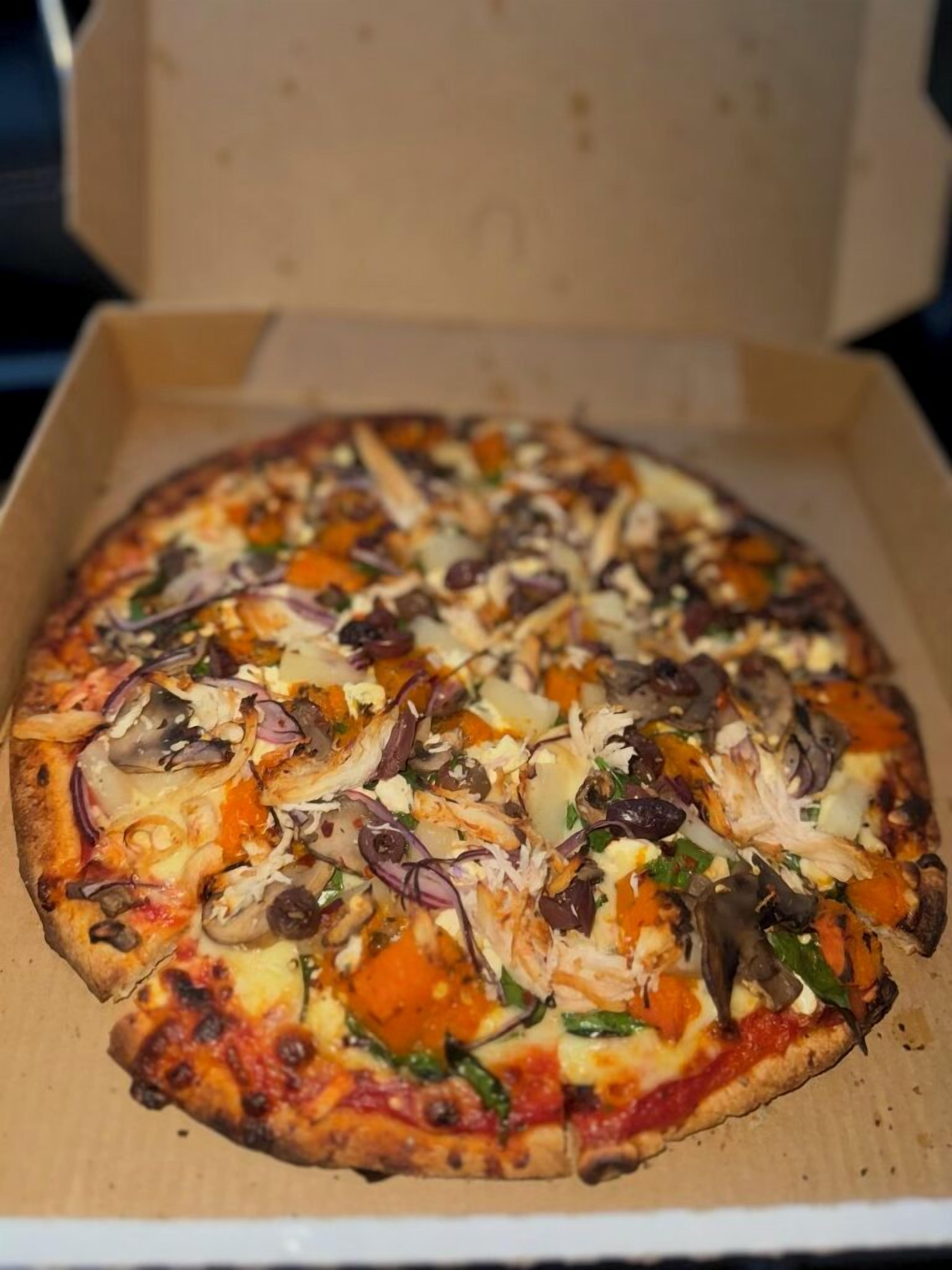 A pizza in a cardboard box.