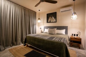 A hotel room with a bed, a nightstand, a ceiling fan, and a window with curtains. - Tulum Penthouse · 3 King Suites · Rooftop Pool (Tulum Municipality)