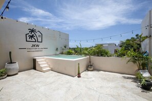 A rooftop with a swimming pool, a staircase, and a sign for JKW Vacation Club Rentals & Membership. - Tulum Penthouse · 3 King Suites · Rooftop Pool (Tulum Municipality)