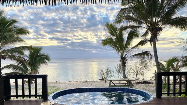 A wooden deck with a pool, palm trees, and a view of the ocean. - Manta-Ray Beach Unit 2 (Rarotonga)