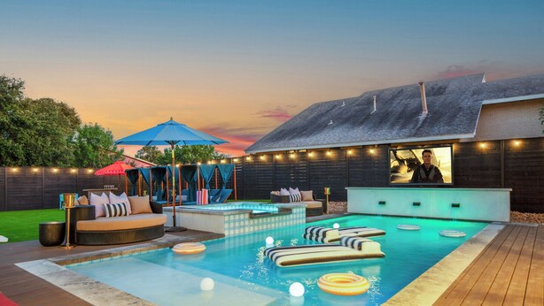 A backyard with a swimming pool, lounge area, and a bar. - Most EPIC Austin Experience! Sleeps 14 + heated Pool + Spa + Cabanas + Speakeasy (Austin)