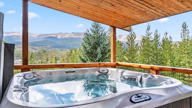 A hot tub with a wooden deck and a mountain view. - Breckenridge Escape with Hot Tub & Mountain Views (Breckenridge)