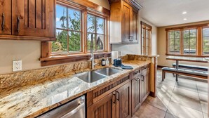 A kitchen with wooden cabinets, granite countertops, and large windows. - Breckenridge Escape with Hot Tub & Mountain Views (Breckenridge)