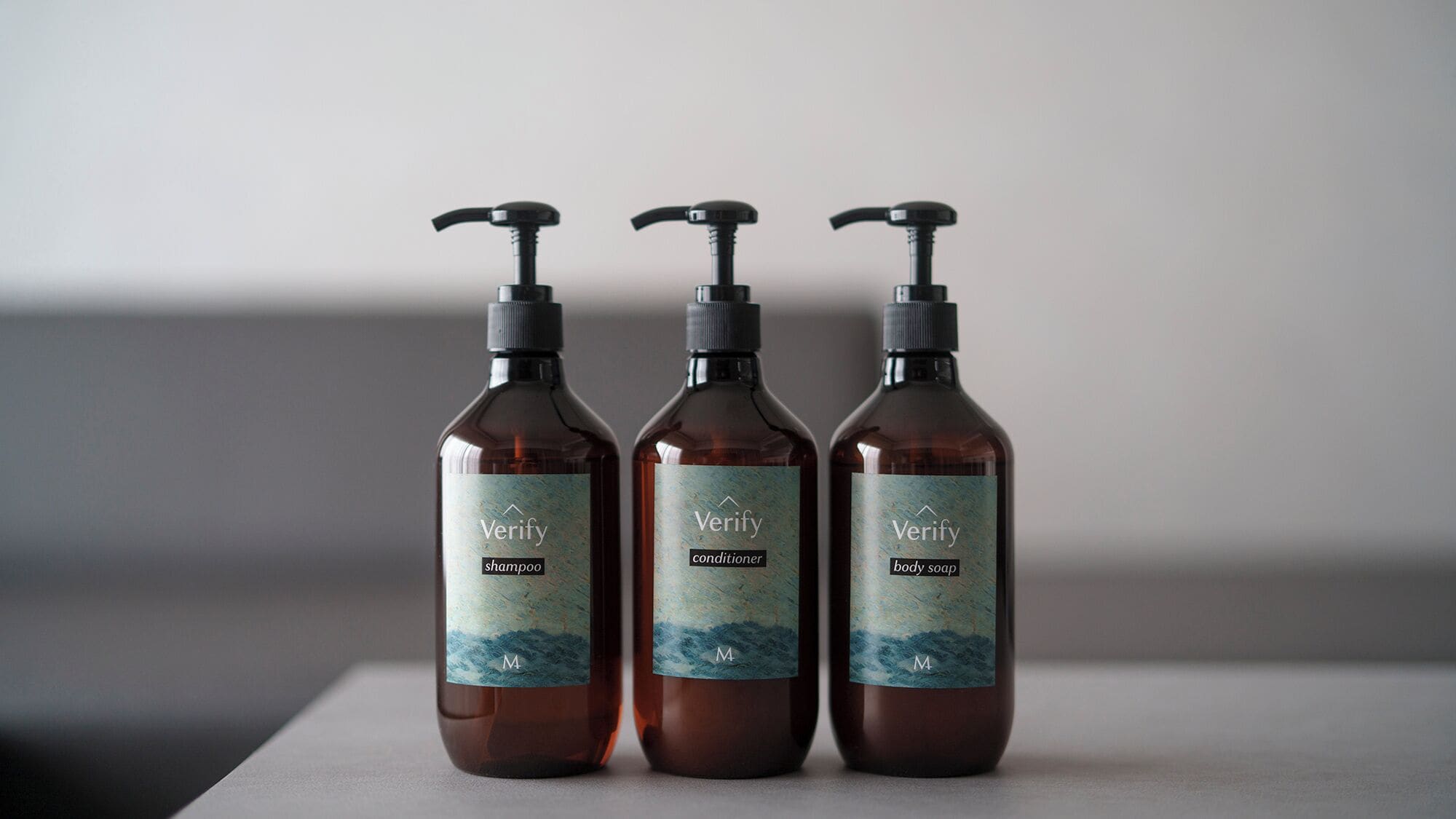 Três frascos de shampoo, condicionador e sabonete líquido Verify.