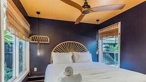 A bedroom with a large bed, a ceiling fan, and a window with blinds. - Nestled on Nautilus (Kingscliff)
