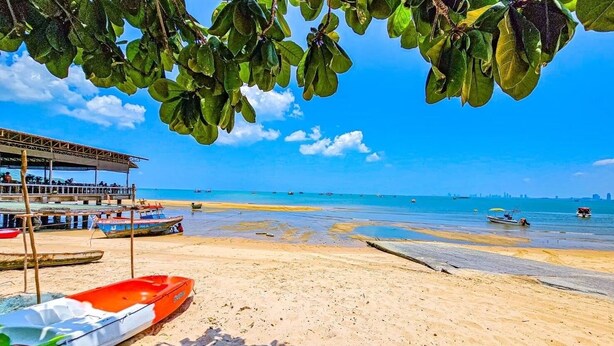 A beach with boats, a covered area, and a clear sky. - Mahasamut coastal Poolvilla (Sattahip)