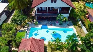 A two-story house with a swimming pool surrounded by greenery. - Lyndale Lodge (Sam Roi Yot)